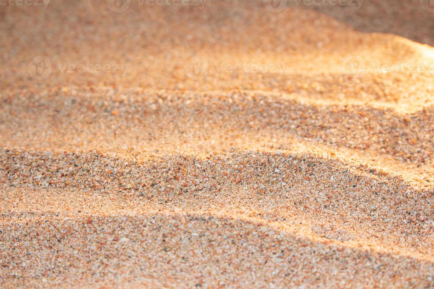 Beautiful beach with yellow sand with small pebbles in sunny day. Panoramic view. Natural background for summer vacation. Sunset, dawn. Copy space photo