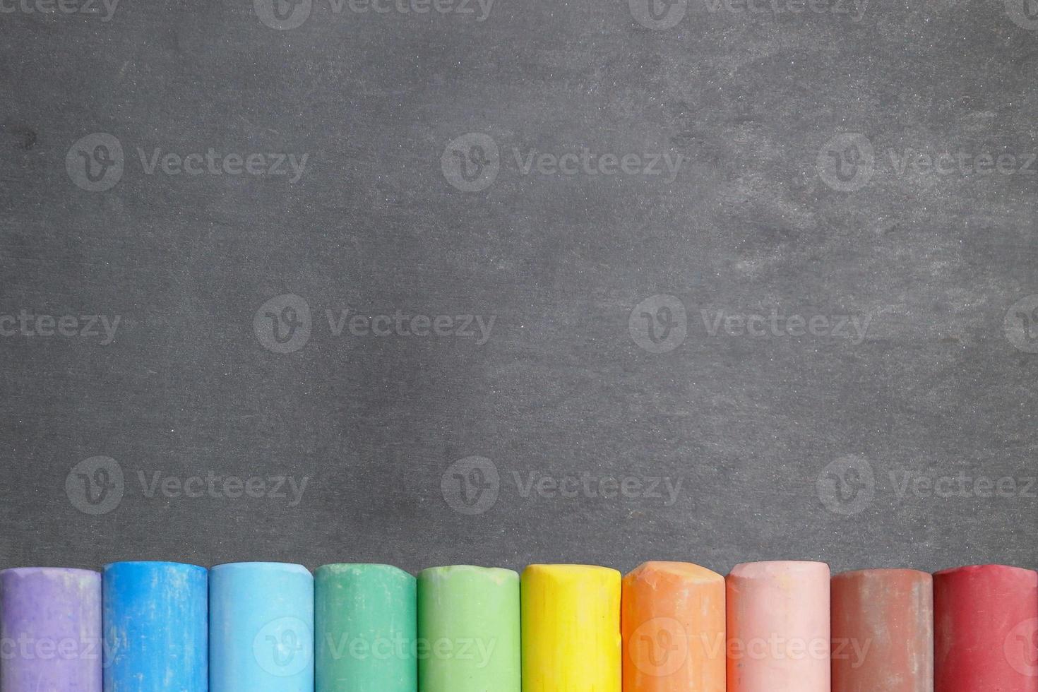 Blackboard with colorful chalk sticks photo