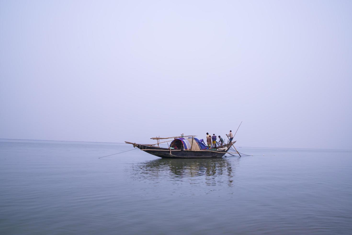 19th February 2023, Landscape view of Fisherman Catch of fish on a Traditional fishing boat  in the Padma River, Faridpur, Bangladesh photo