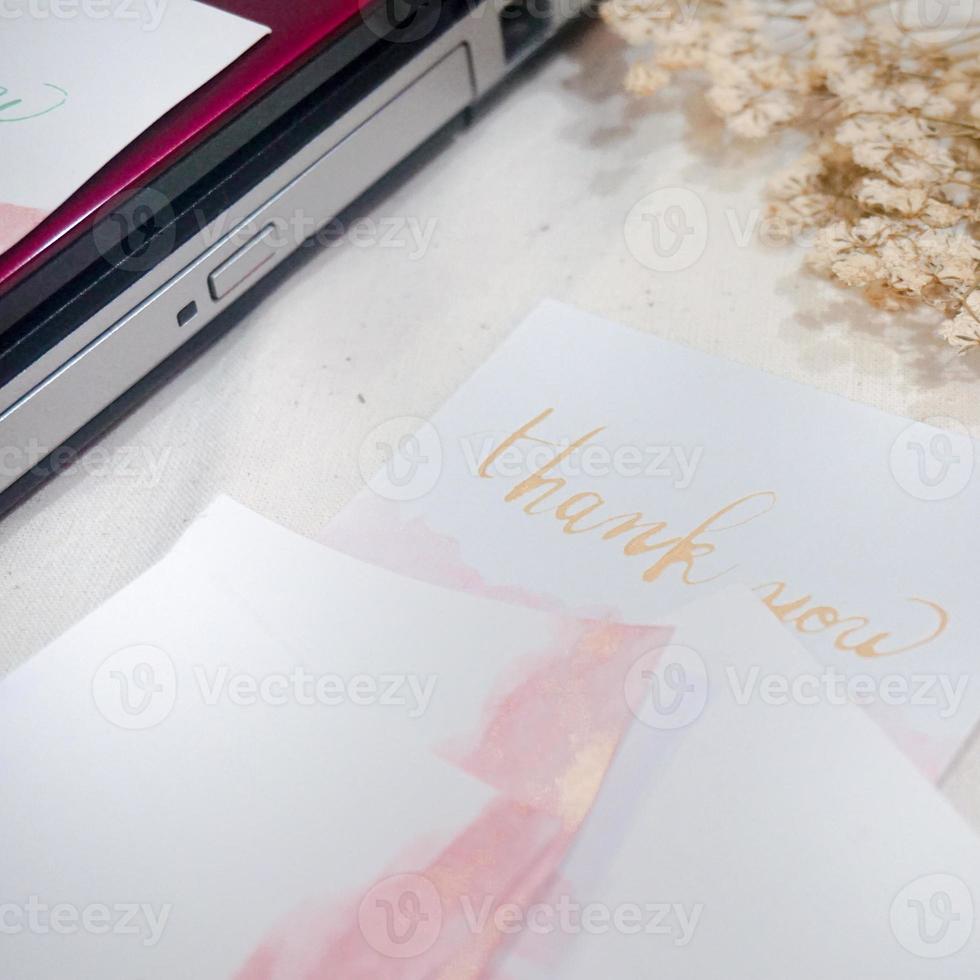 A white card with the word thank you written on it photo