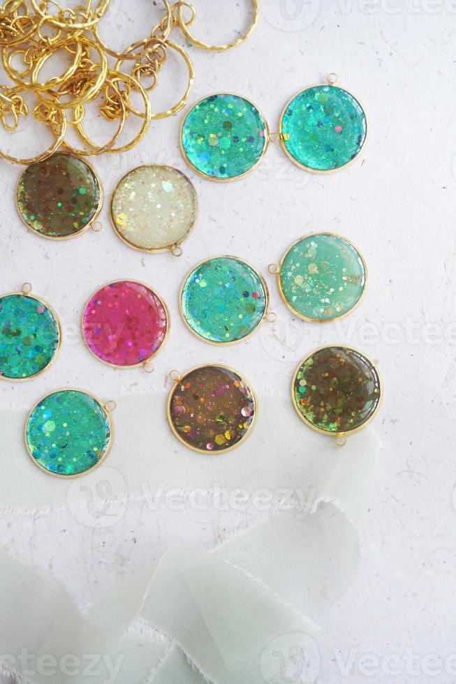 A collection of colorful glass beads are displayed on a white surface. photo