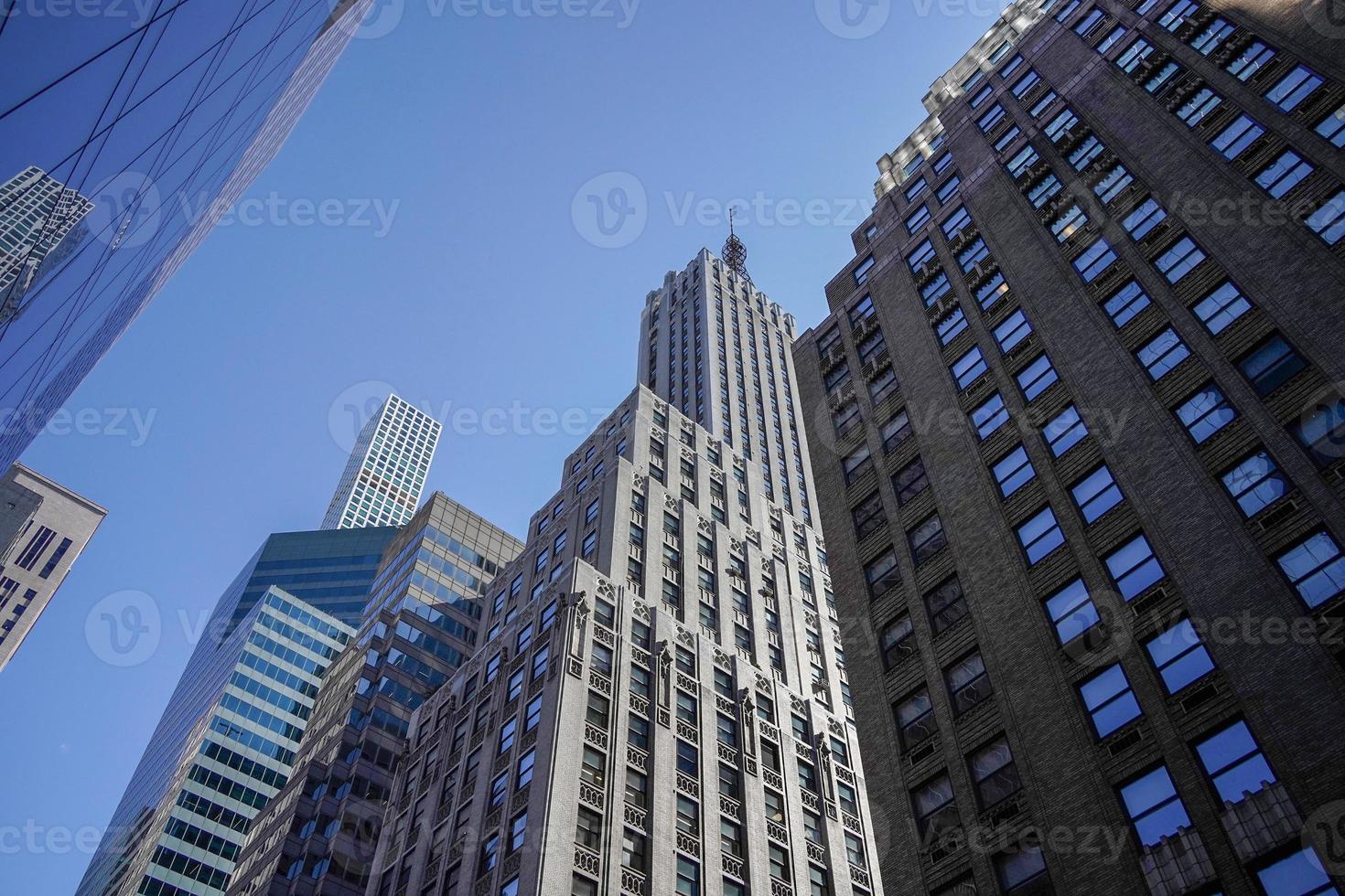 new york manhattan skyscrapers view from the street to the top of the building on sunny clear day photo