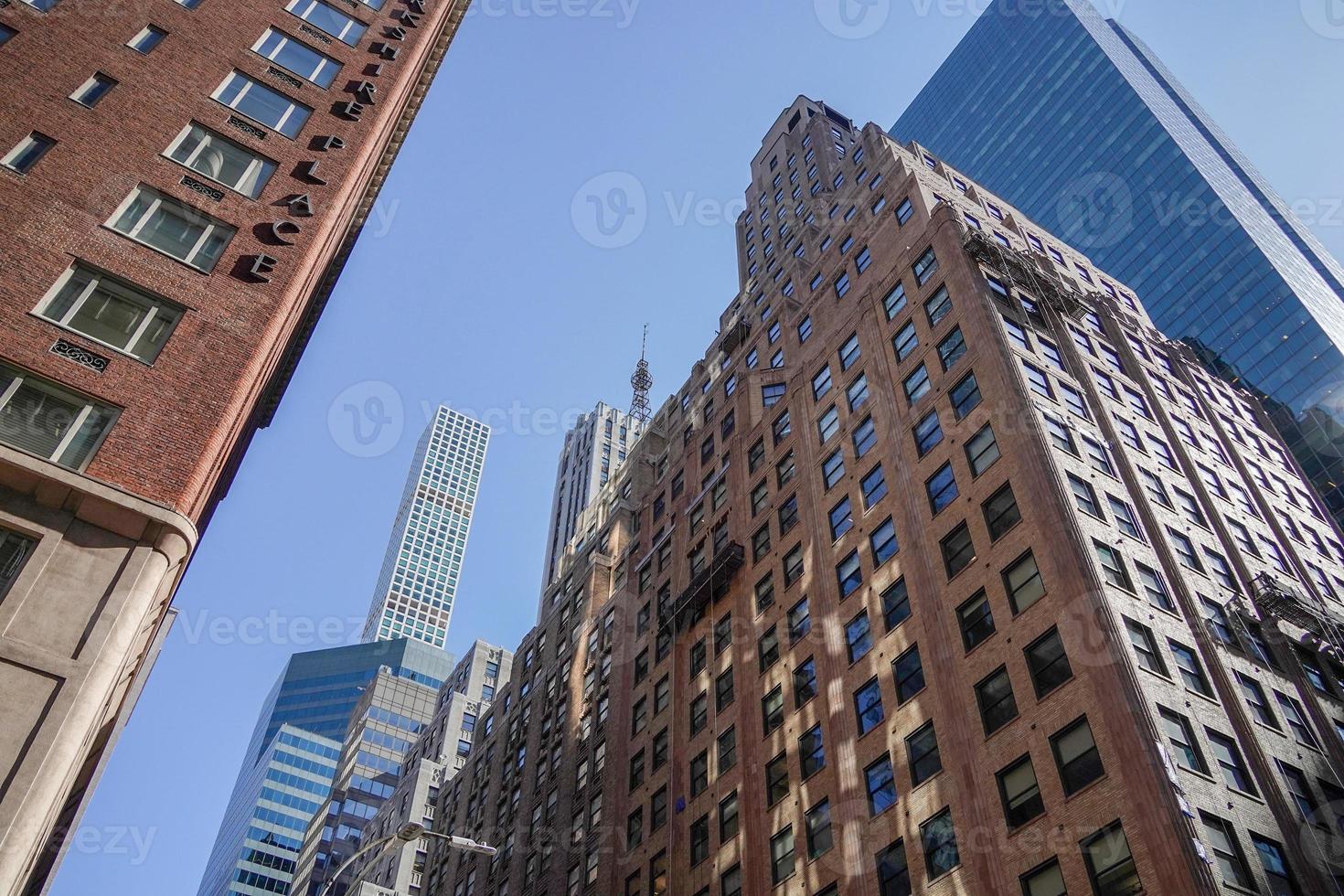 new york manhattan skyscrapers view from the street to the top of the building on sunny clear day photo