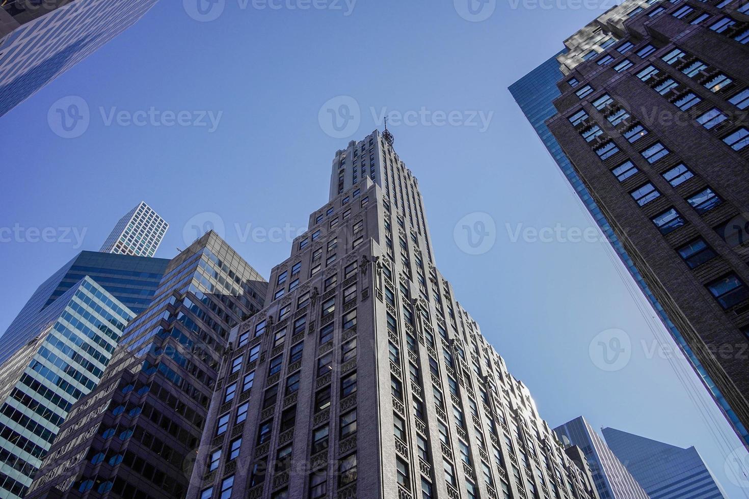 new york manhattan skyscrapers view from the street to the top of the building on sunny clear day photo