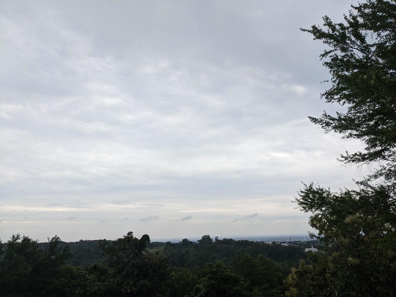Landscape of hilltop with cloudy vibes when rain season. The photo is suitable to use for environment background, nature poster and nature content media.