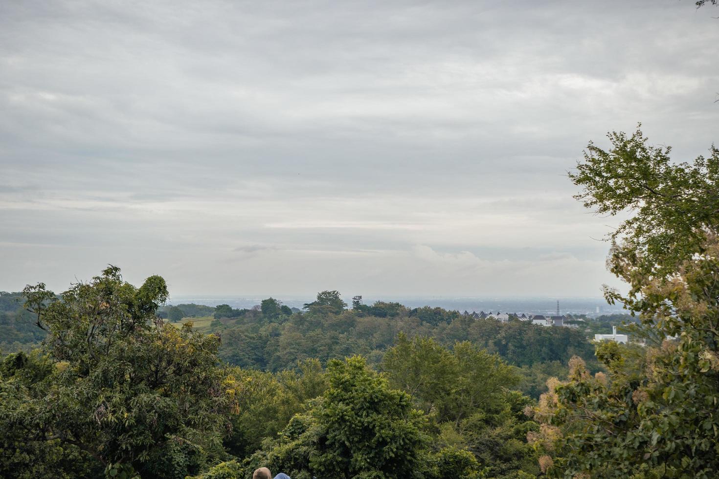 Landscape of hilltop with cloudy vibes when rain season. The photo is suitable to use for environment background, nature poster and nature content media.