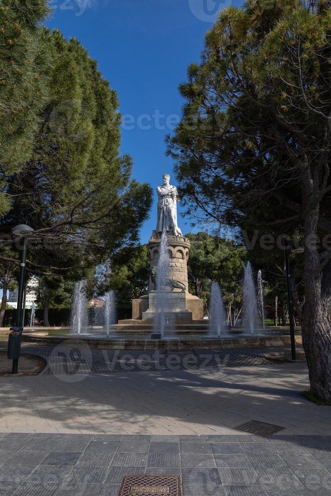 big king statue in a park in Zaragoza, Spain on a warm spring day photo