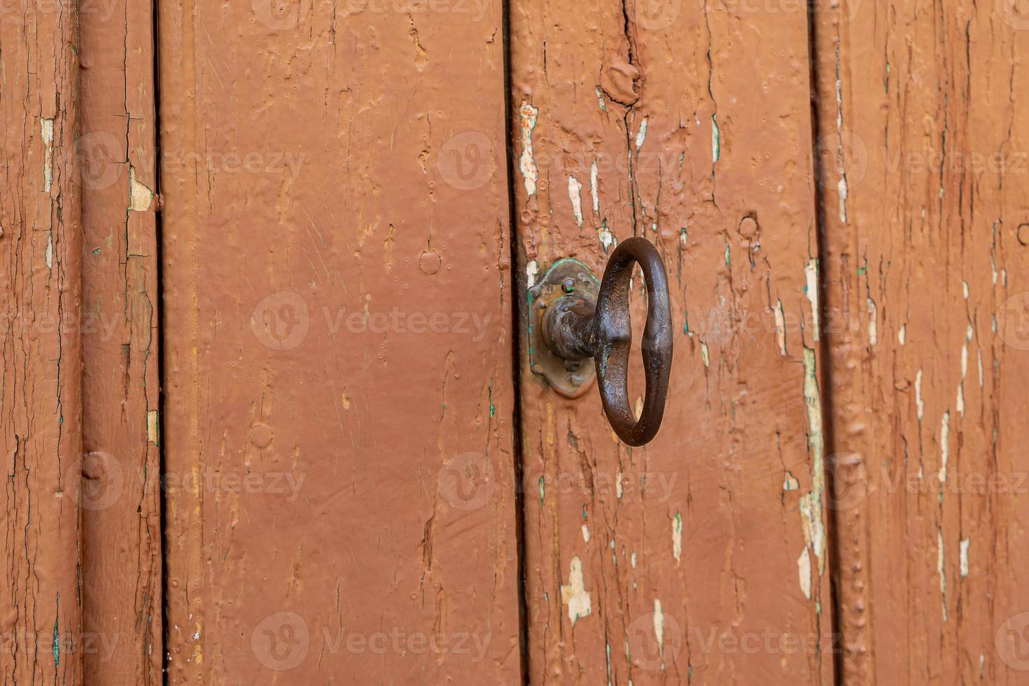 old vintage brown wooden door with metal handle photo