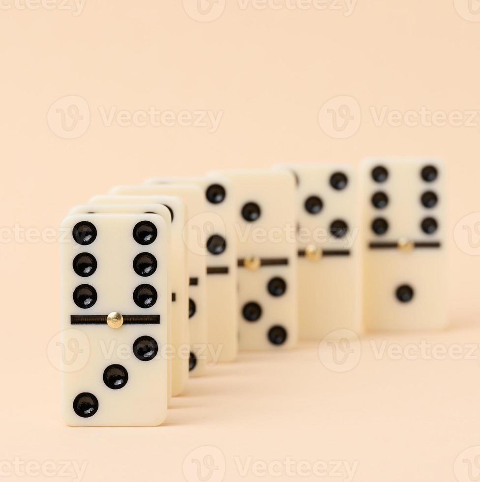 A stack of dominoes on a beige background, an intellectual game photo