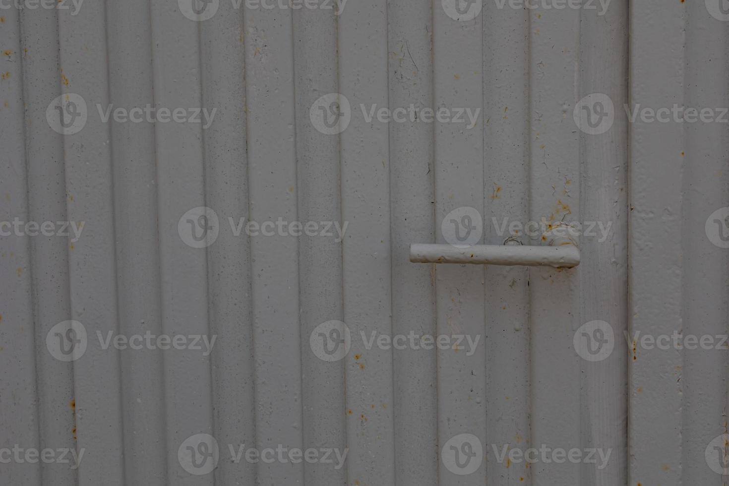 door handle on a background of a gray gate as a background photo