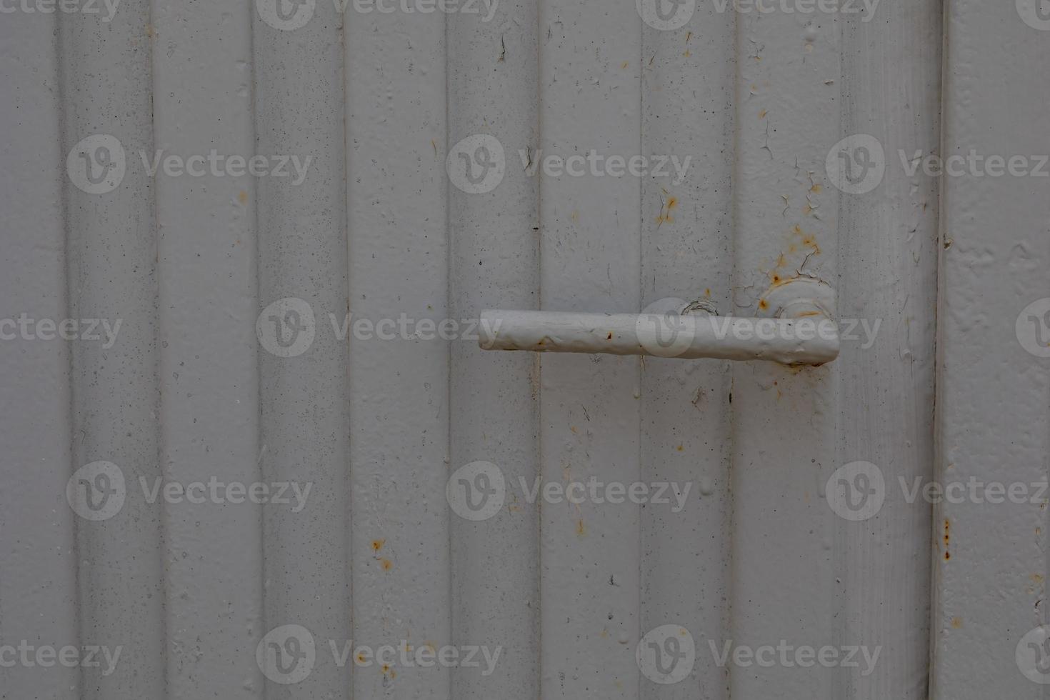 door handle on a background of a gray gate as a background photo