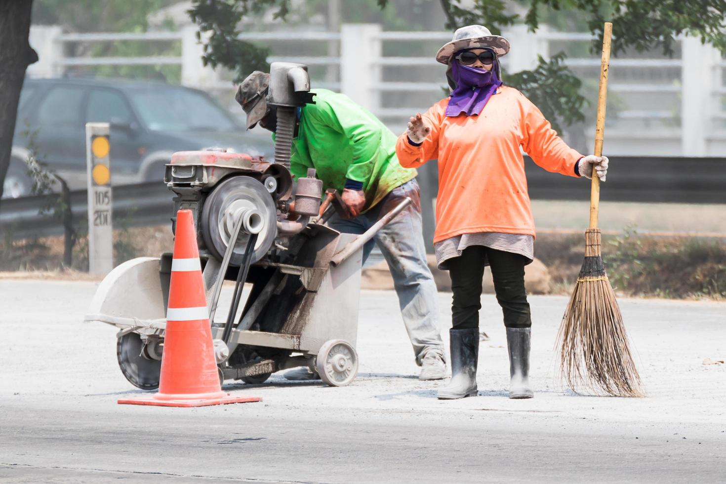 Worker cutting asphalt road photo