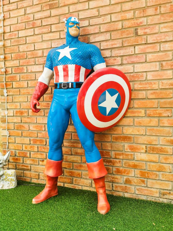 Captain America model beside the brick wall photo