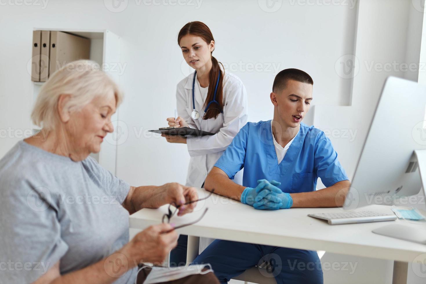 a nurse and a doctor communicate with an elderly woman patient hospital health care photo