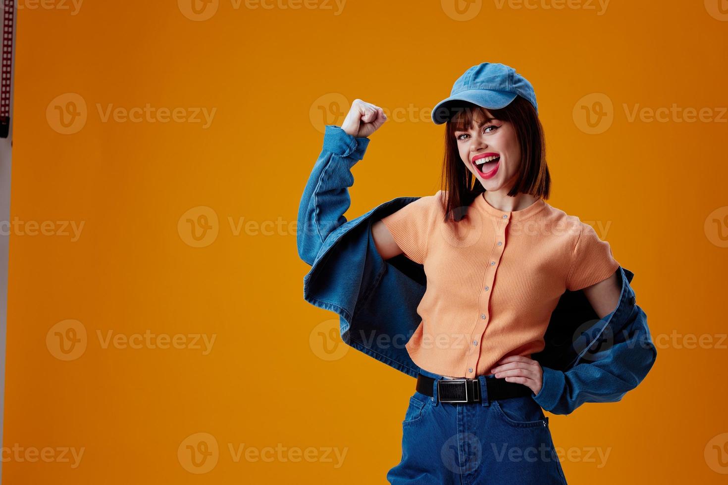 pretty woman stylish denim clothing posing yellow background unaltered photo