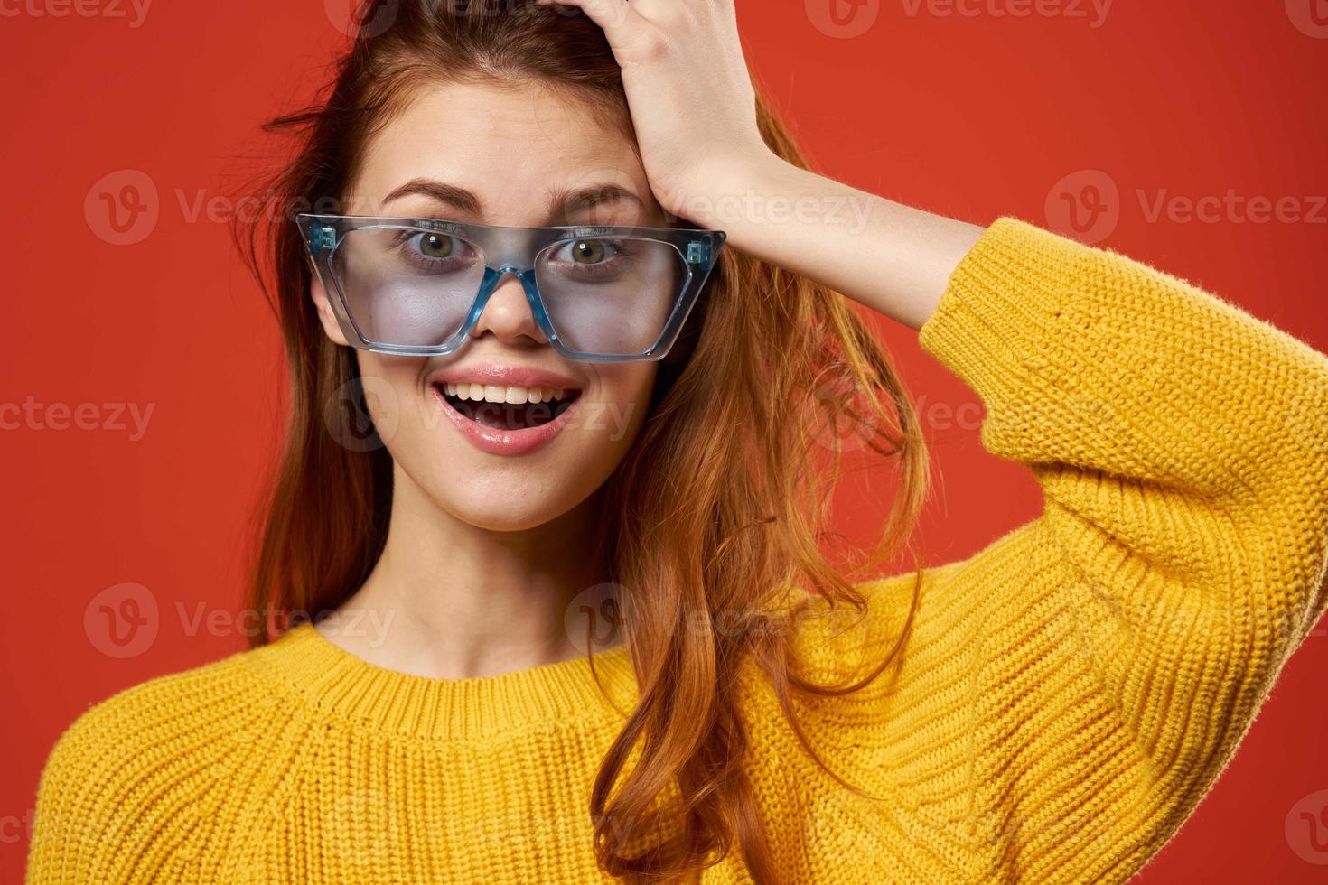 cheerful woman in yellow sweater blue glasses posing studio photo