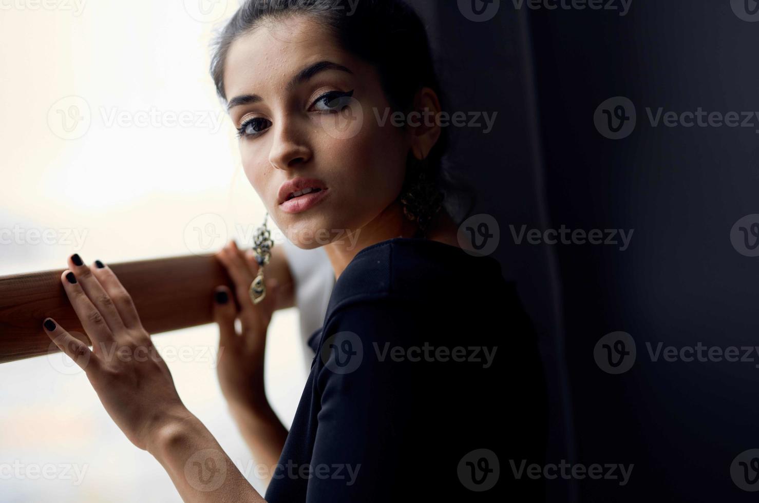 pretty woman holding a camera near the window decoration fashion elegant style photo