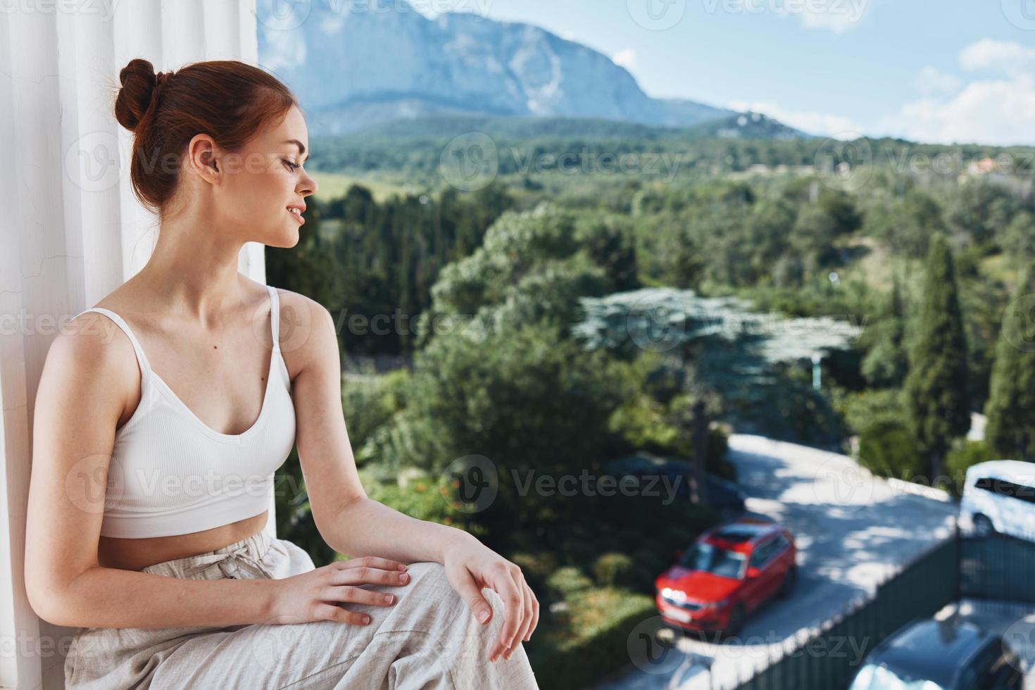 woman sitting on a balcony outdoors hotel vacation luxury photo