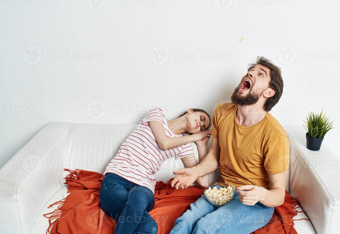 Emotional man and woman on the couch orange plaid flower in a pot chatting friends photo