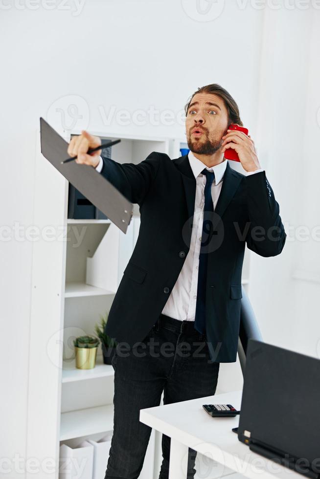 man in a suit in the office with documents executive photo