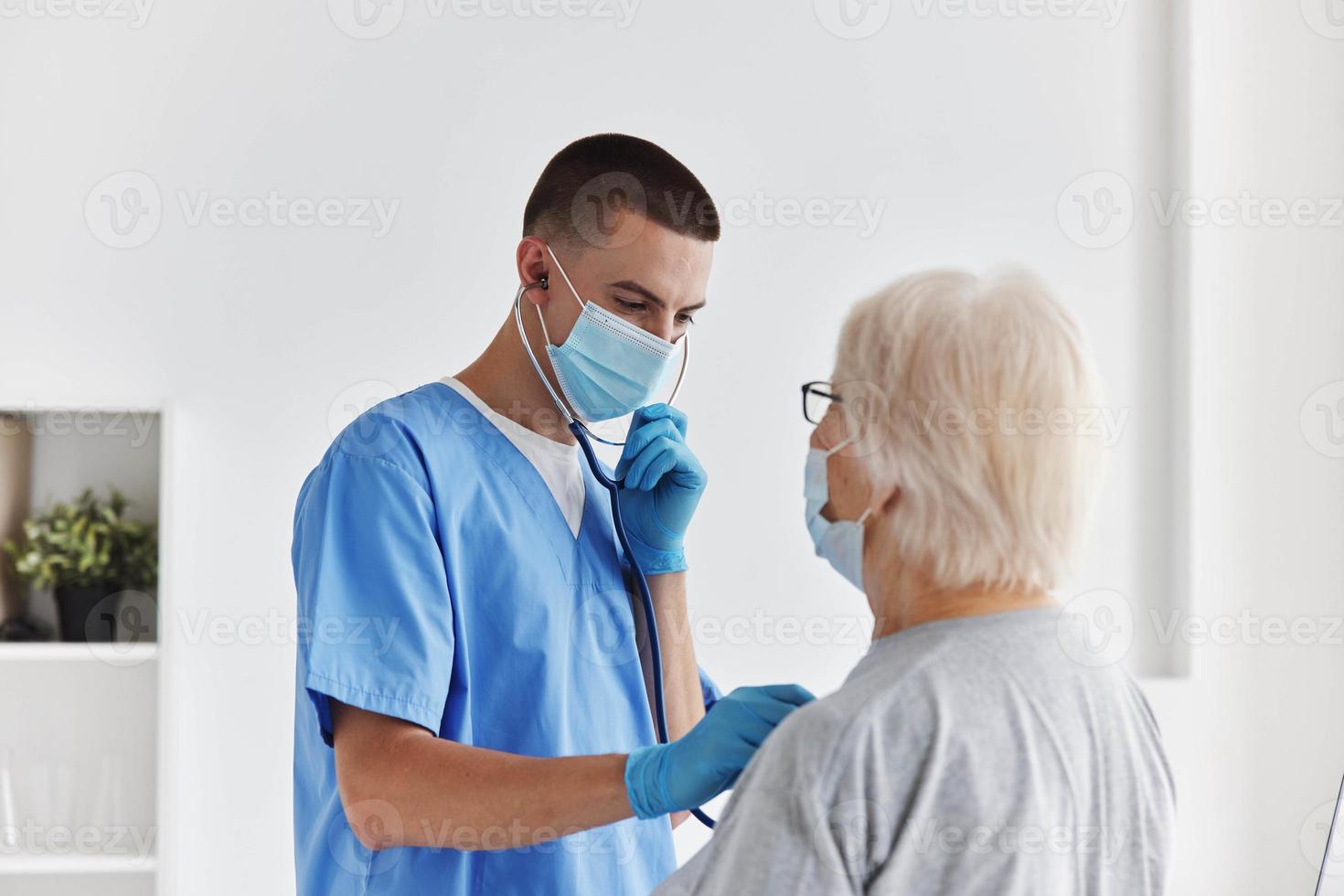 male doctor listens to the patient checkup photo