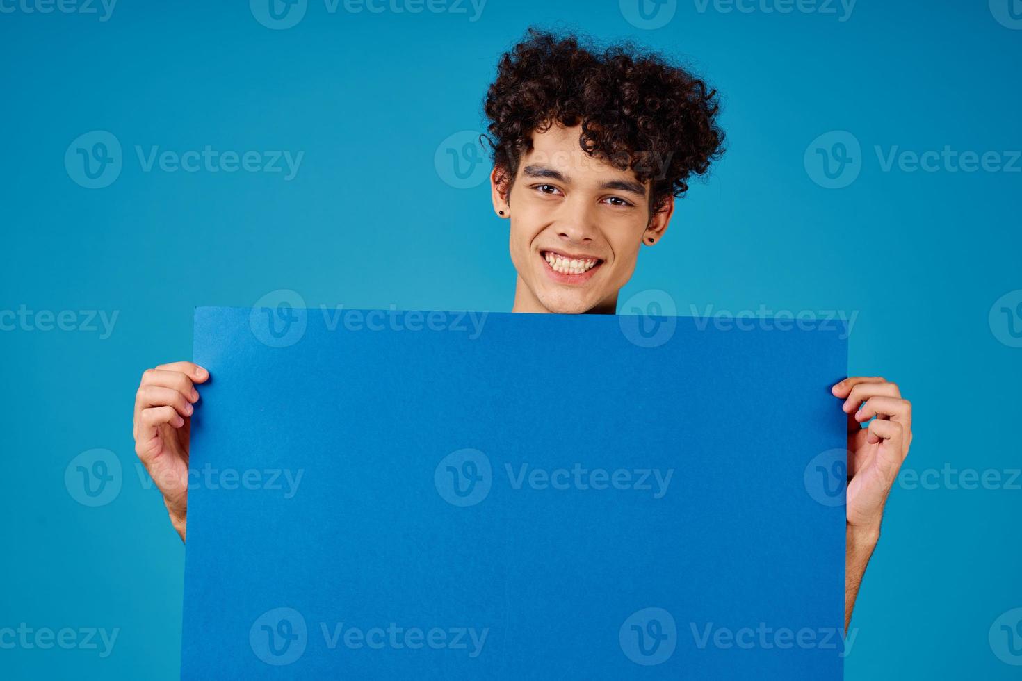 Cheerful guy with curly hair blue mockup Poster Studio photo