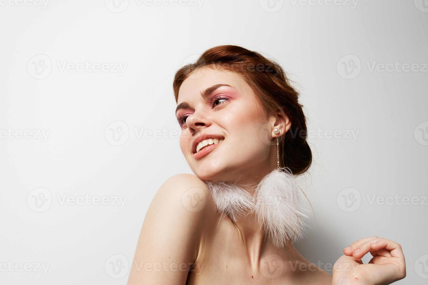 attractive women fluffy earrings nude shoulders cosmetics photo