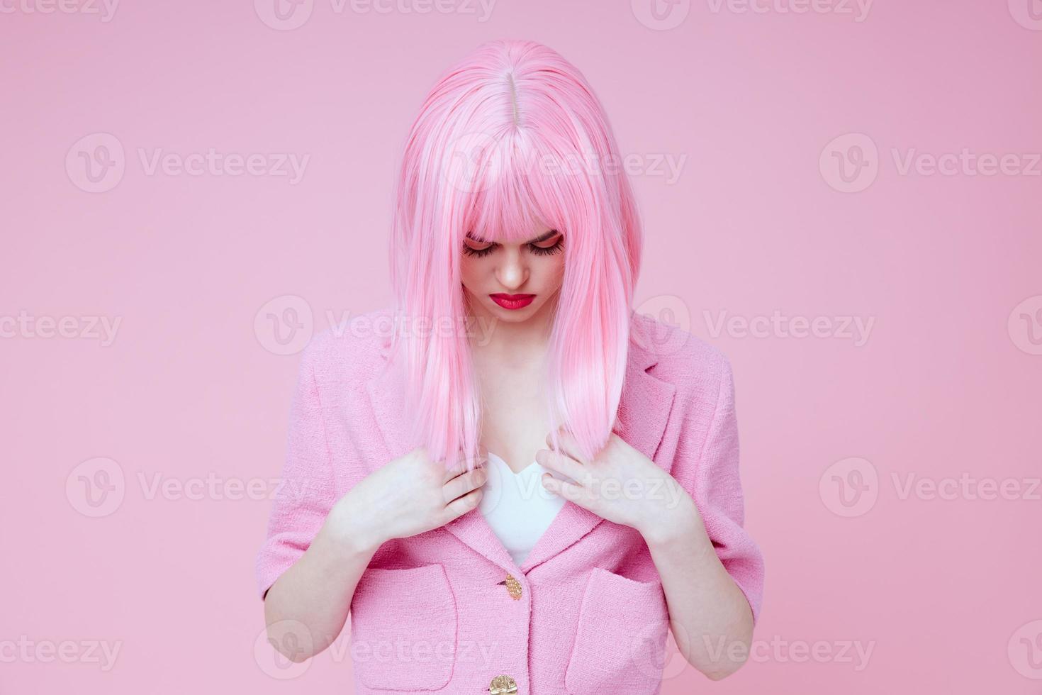 Young positive woman gestures with his hands with a pink jacket color background unaltered photo