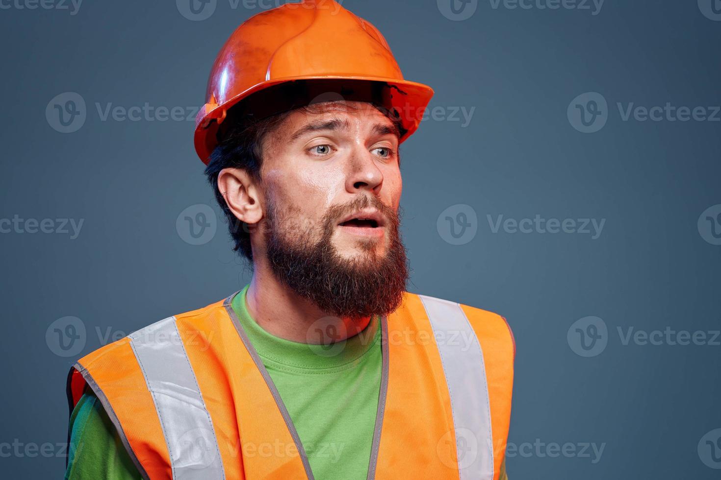 Angry man in work uniform orange paint safety hard work cropped view photo