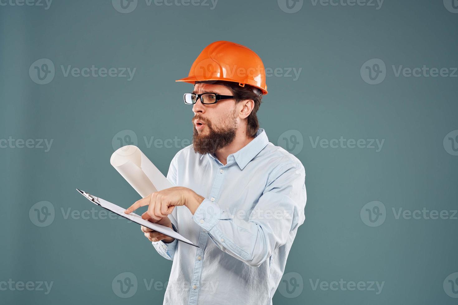 man worker with documents in hands wearing glasses orange helmet safety professional photo