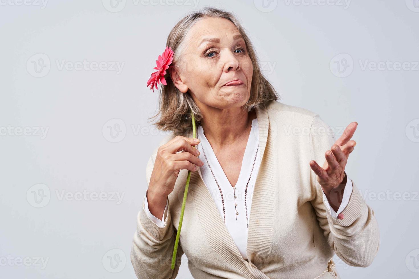 elderly woman holding a flower birthday holiday gift photo