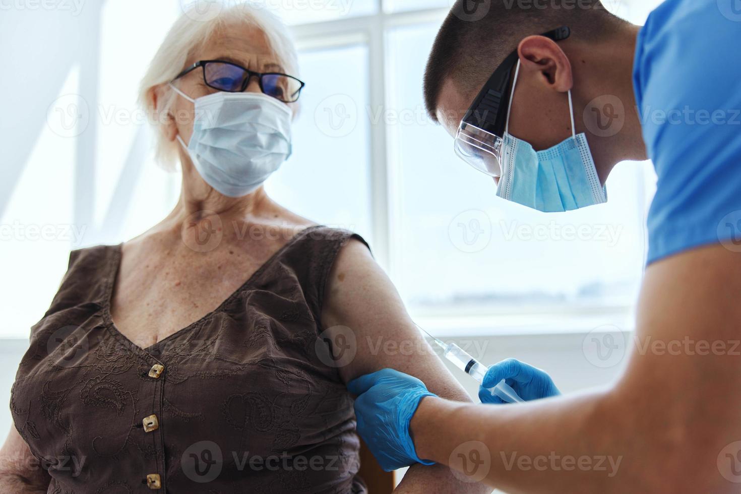 male doctor giving an injection immunity protection pandemic coronavirus photo
