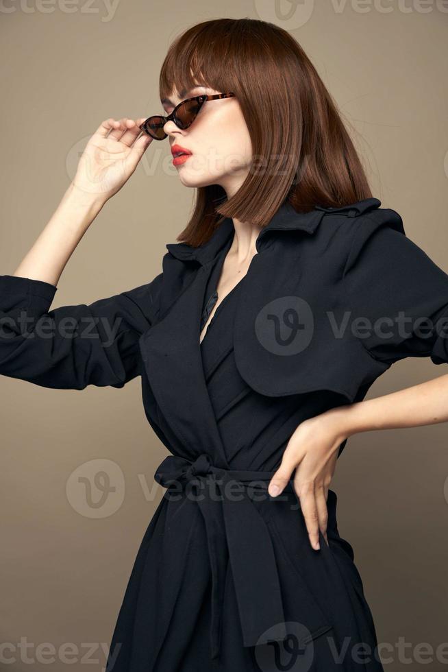 Charming brunette Looks to the side and holds his hand at the waist dark glasses photo