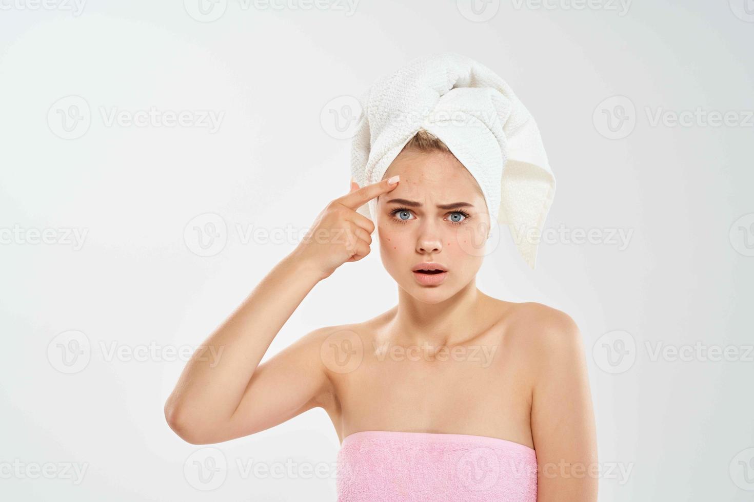 woman with bare shoulders with a towel on her head emotions dissatisfaction hygiene photo