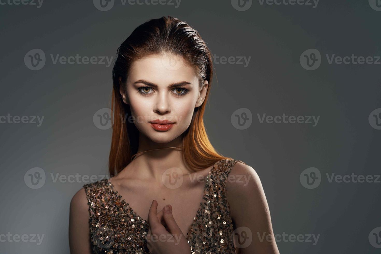 woman in gold dress and earrings jewelry Glamor model photo