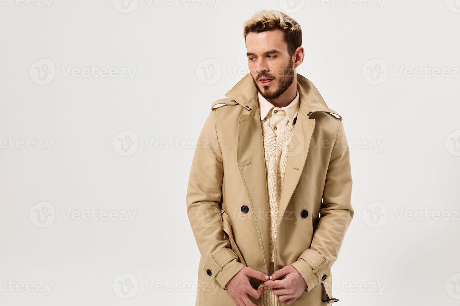 man with serious expression in coat modern style emotions photo