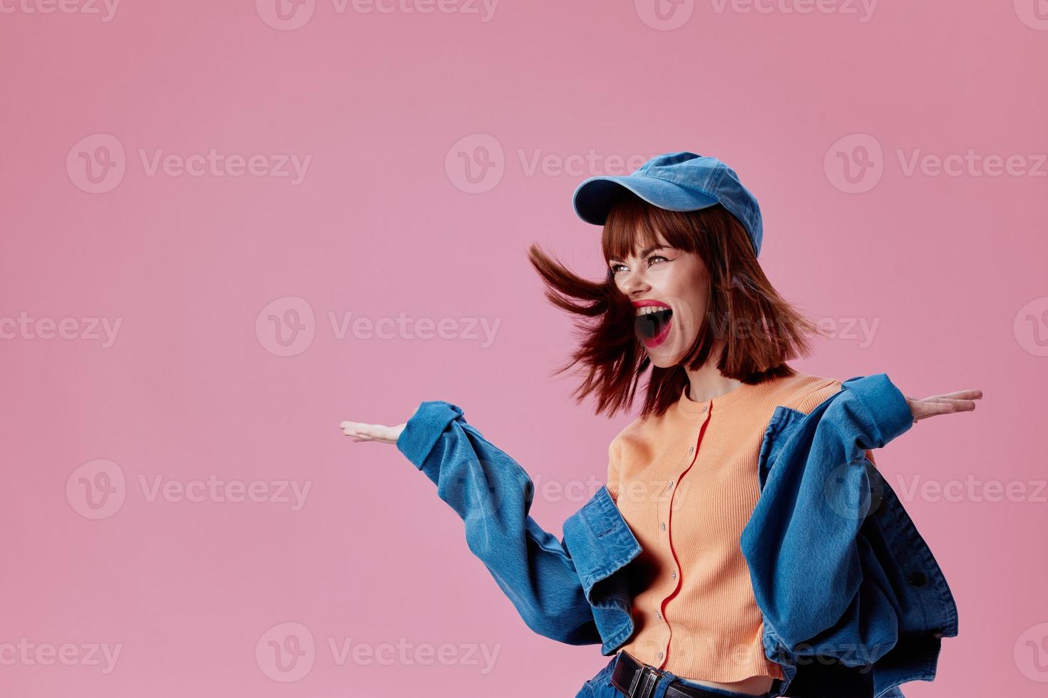 Positive young woman denim cap red lips glamor fashion pink background unaltered photo