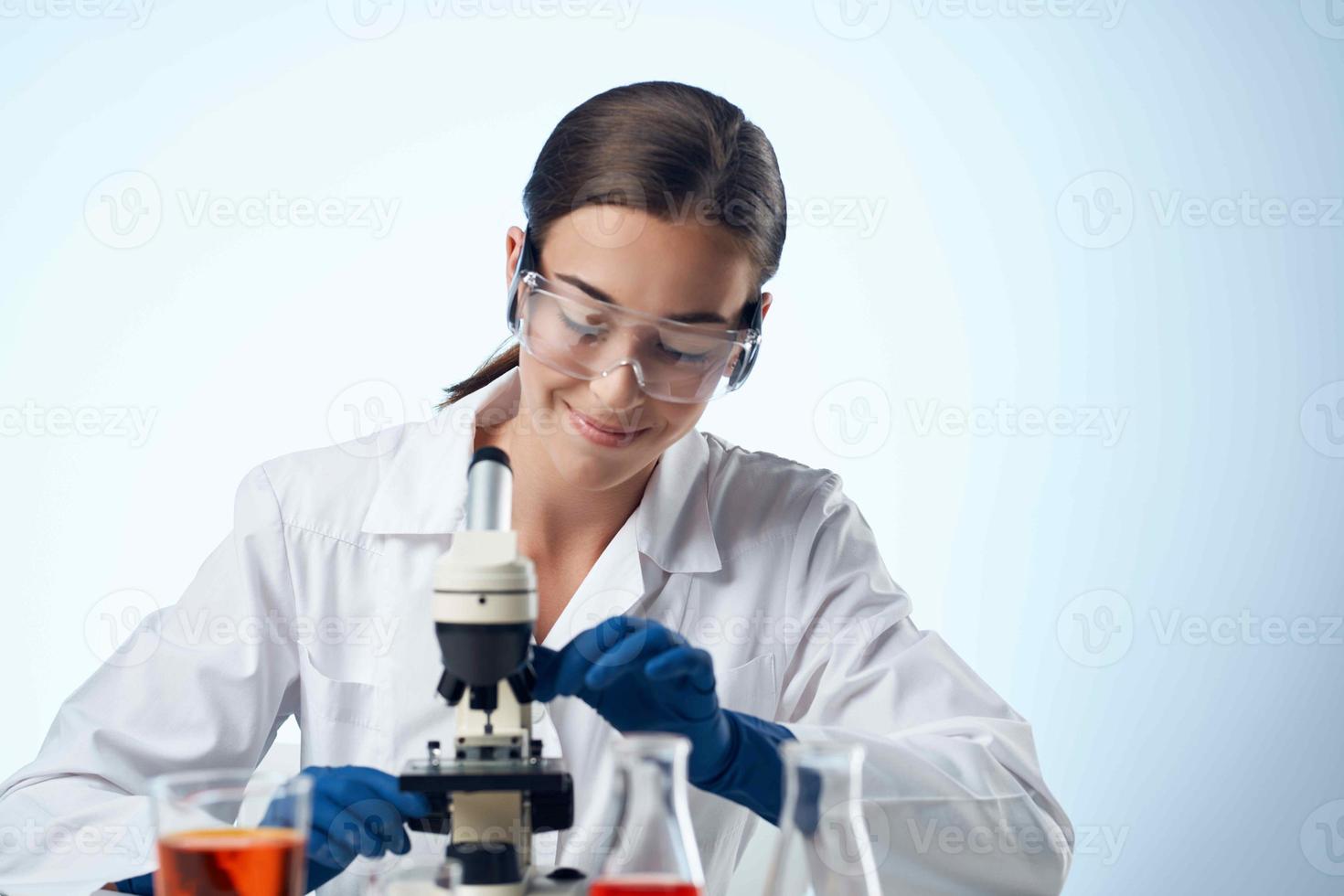 female laboratory assistant at work table microscope professional photo