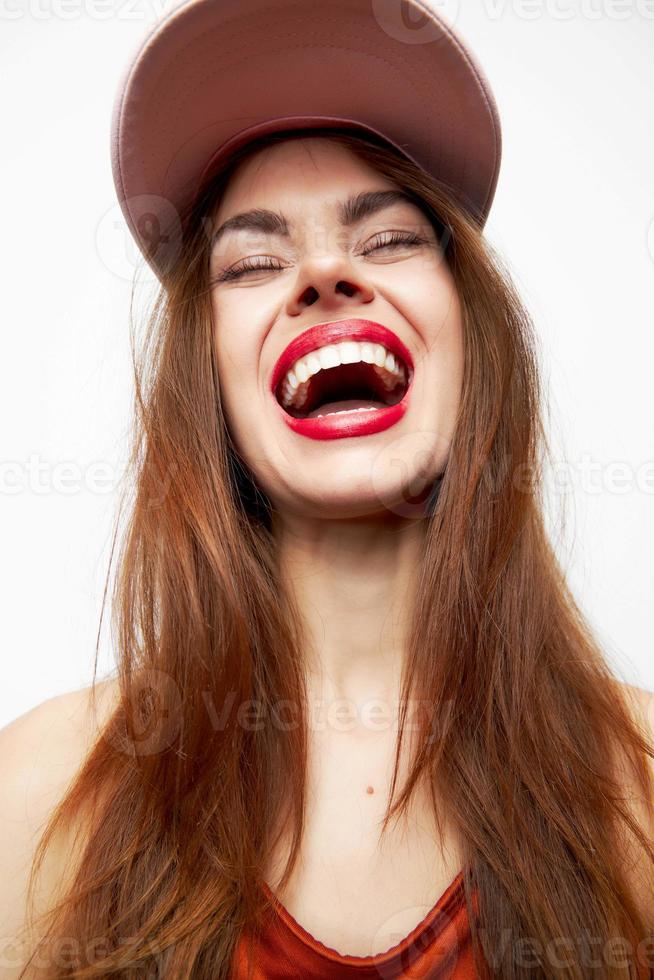 Portrait of a woman in a cap Model wide smile closed eyes evening makeup photo