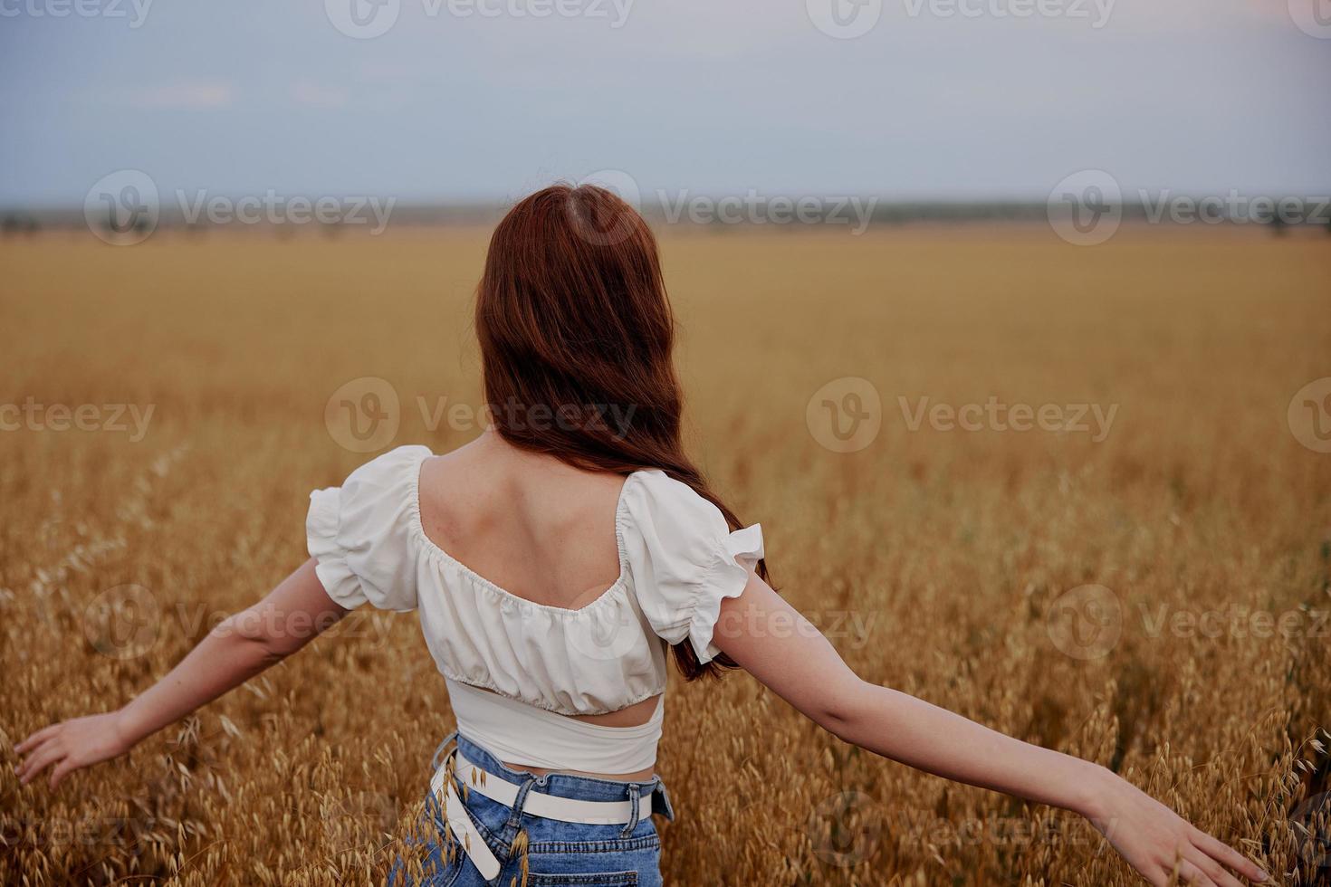 red-haired woman in the field countryside freedom summer photo