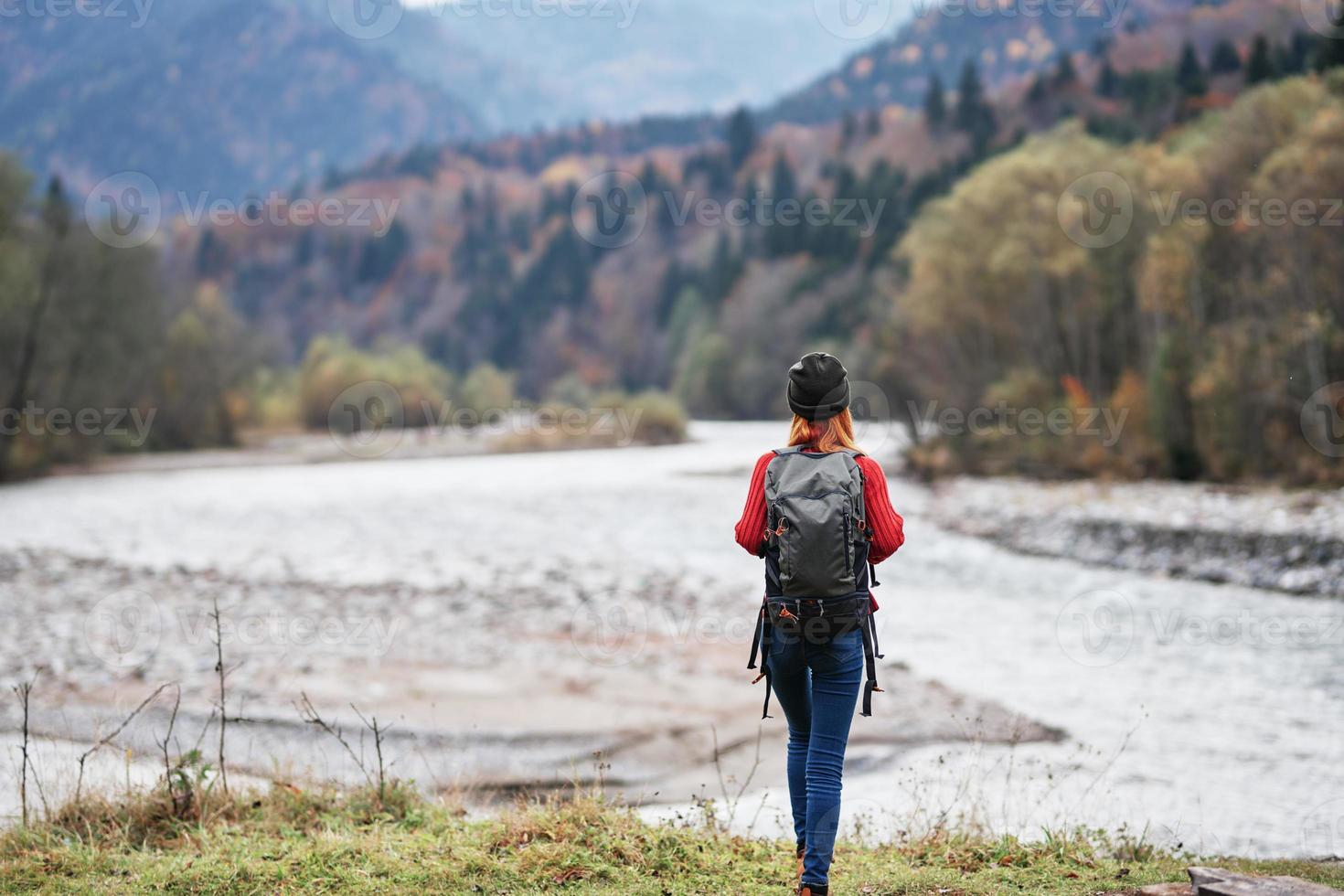 woman on the river bank in the forest and mountains in the background landscape tourism travel photo