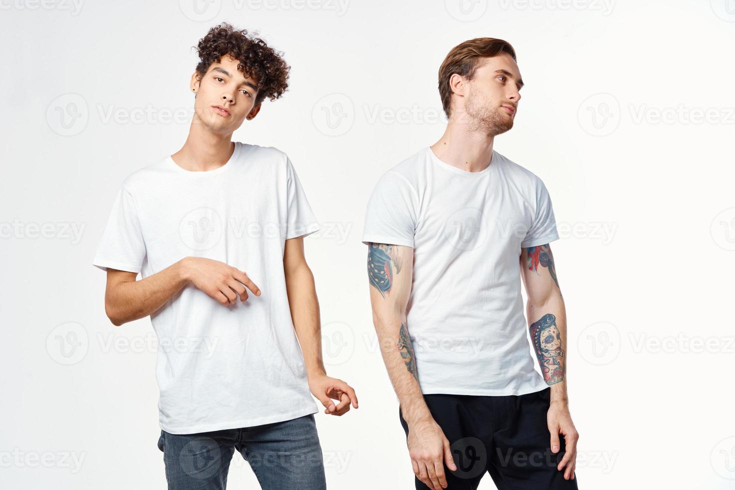 Two cheerful friends in t-shirts stand side by side photo