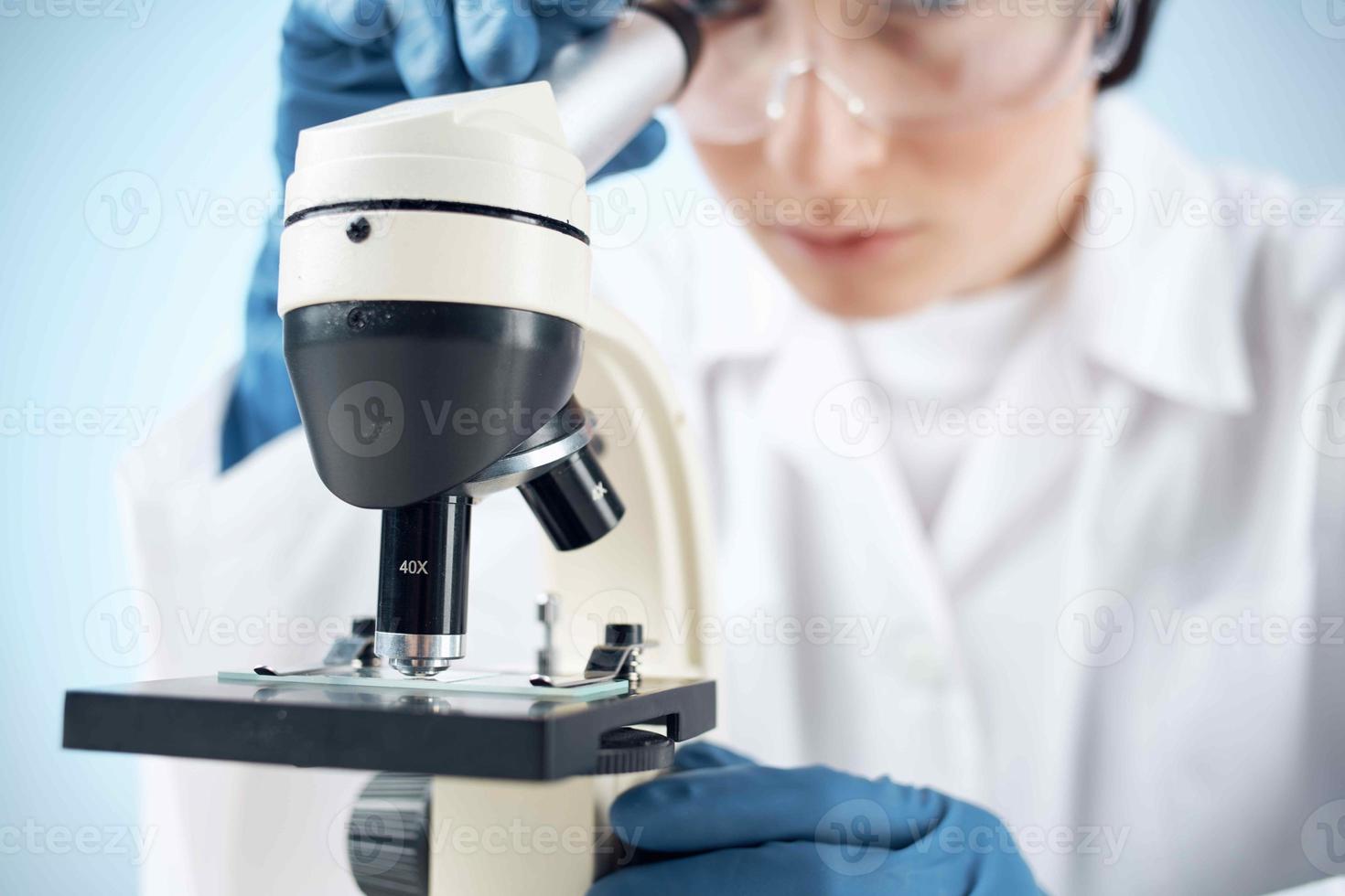 Woman in white coat laboratory microscope work science research photo