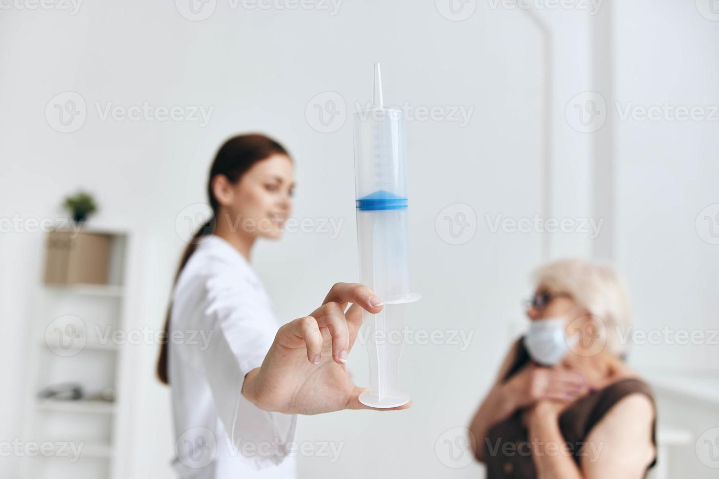 Nurse giving injection to elderly woman vaccination fun photo