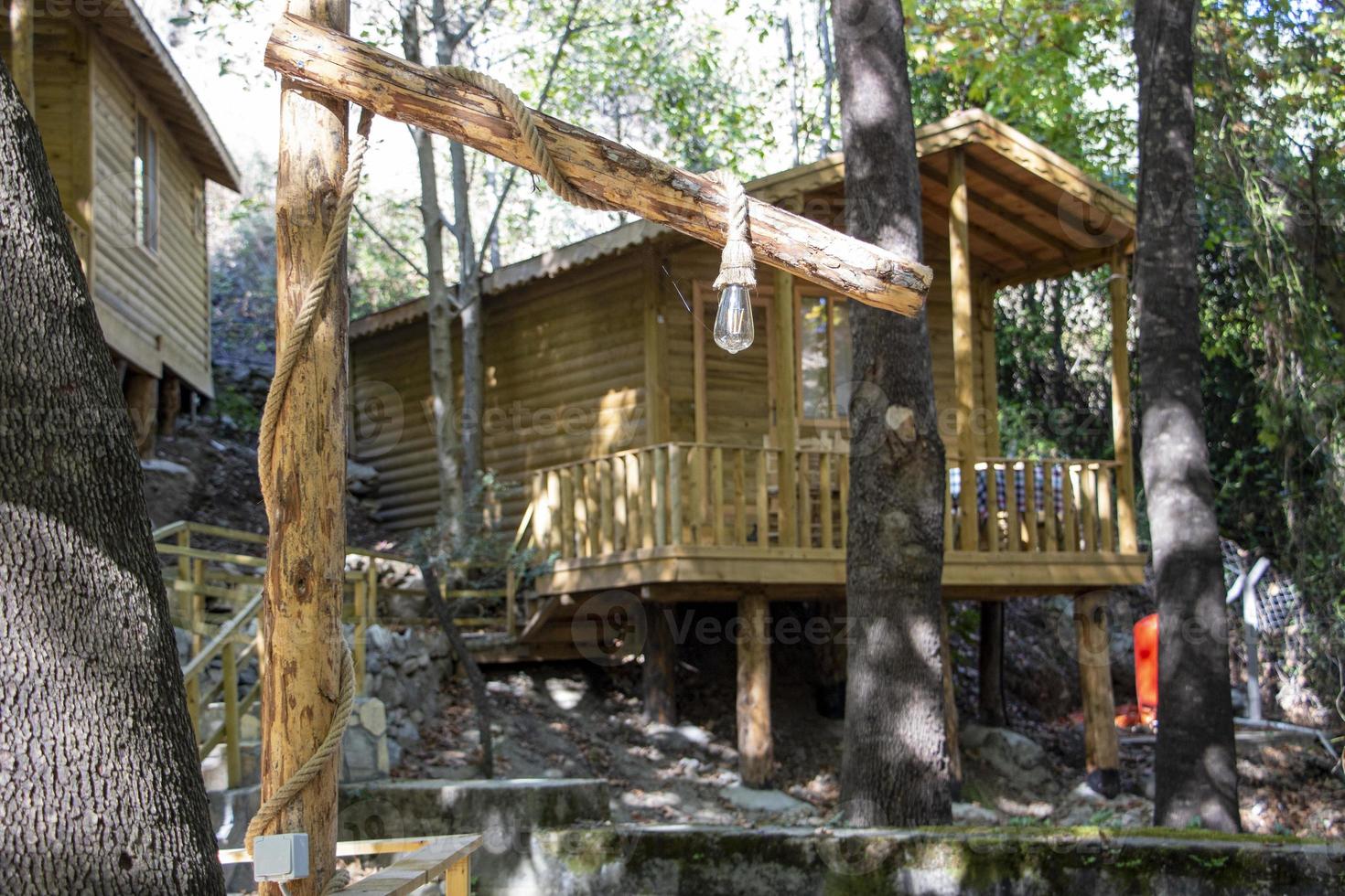 Old house in the middle of the forest with a wooden staircase. photo