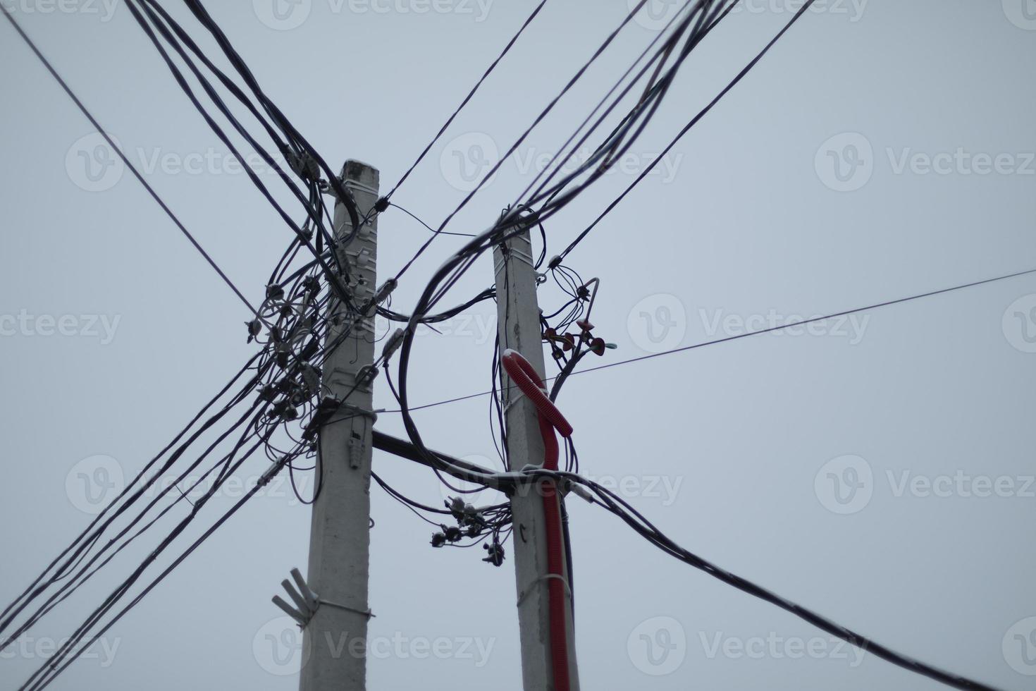 Pole with wires. Electrical wires in details. Concrete pole. photo