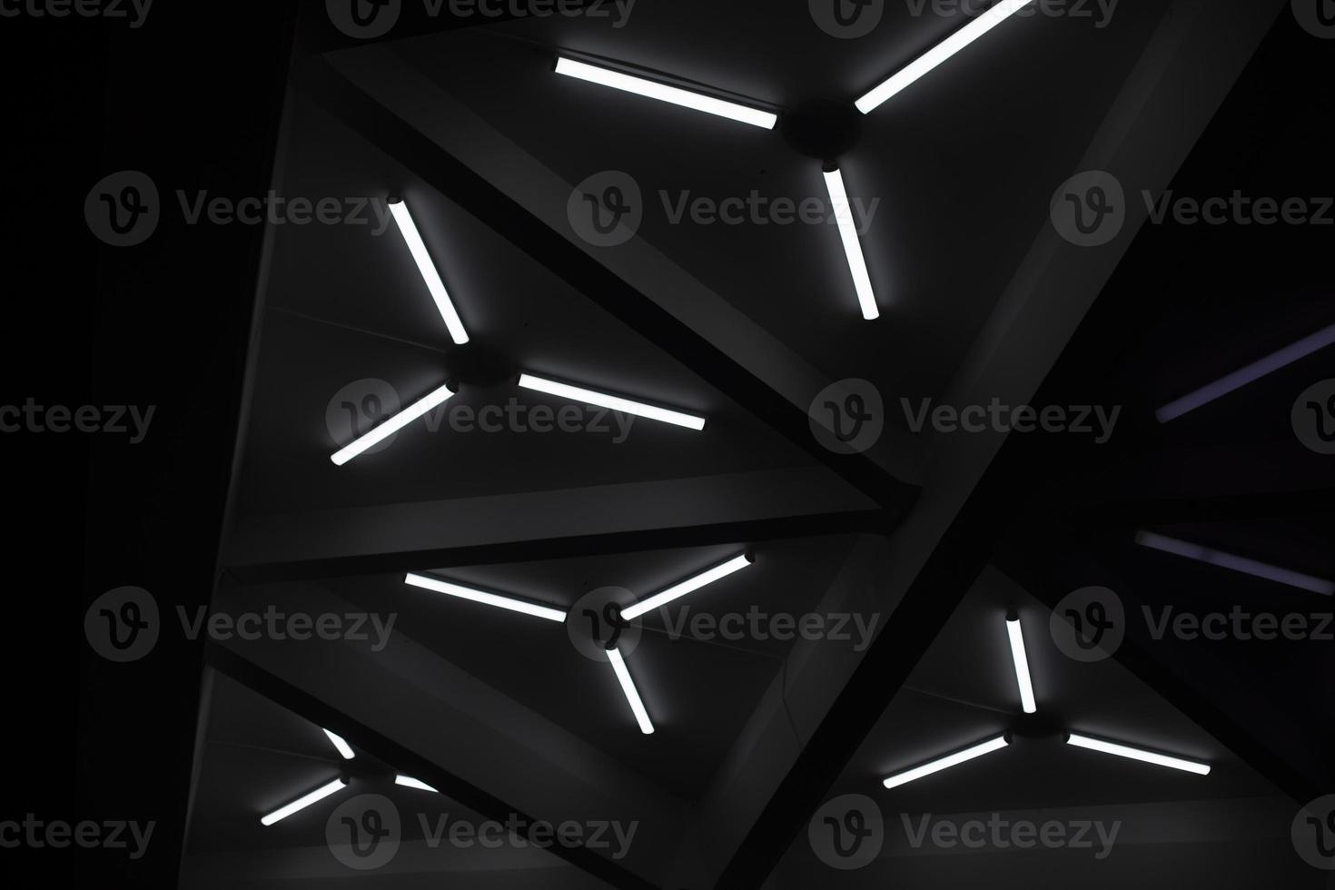 Triangular fluorescent lamps. Ceiling design. Interior details. Futuristic light. photo