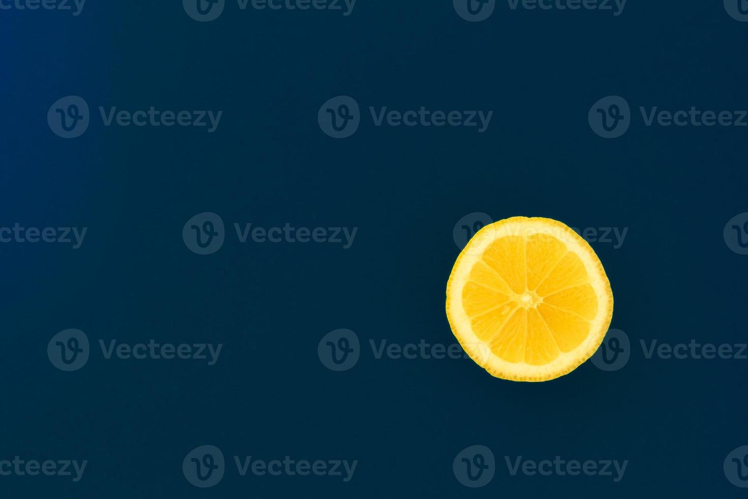 Yellow lemon on a blue background with copyspace. Design, Fine Art, Minimalism photo