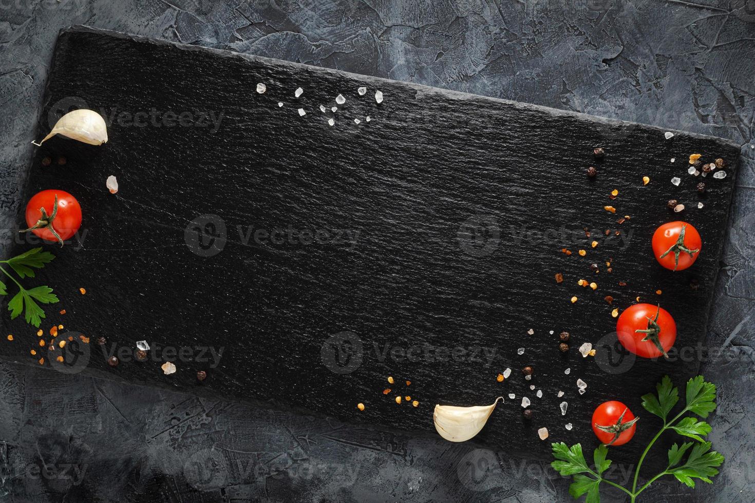 Colorful vegetables composition with tomatoes, spices and greens. Top view. photo