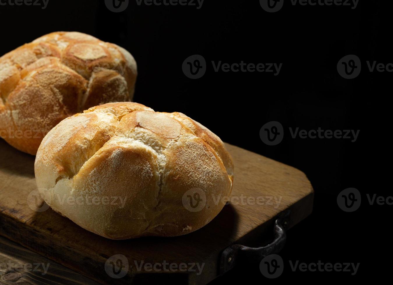 Freshly baked bread on rustic wooden table photo